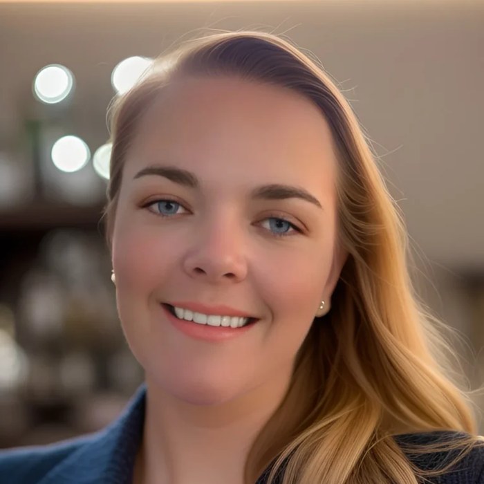 Rebecca Bates smiling, in a navy blazer